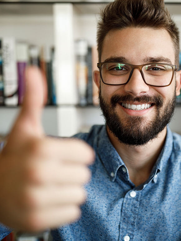 Man in glasses giving thumbs up